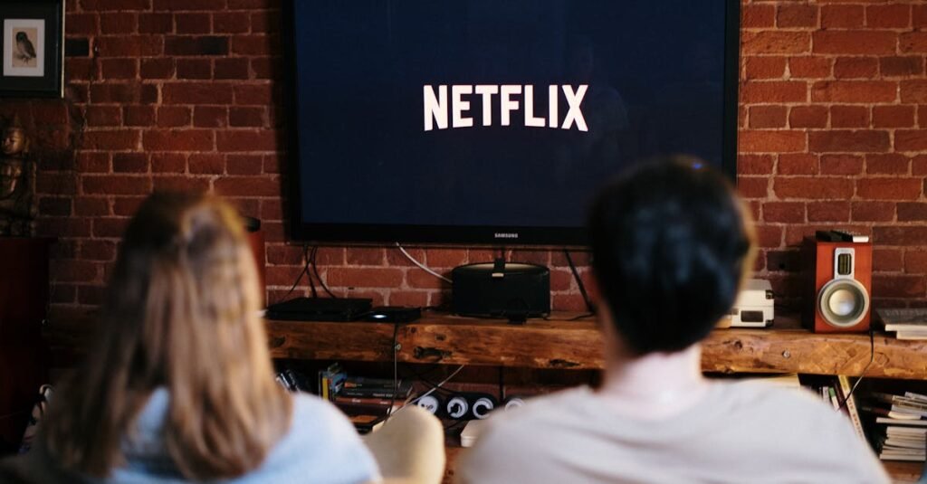 Netflix black friday. A couple relaxing and watching Netflix in a cozy living room setting.